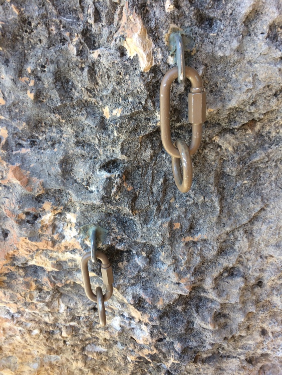 Two rings, one higher than the other, attached by mallions to hangers