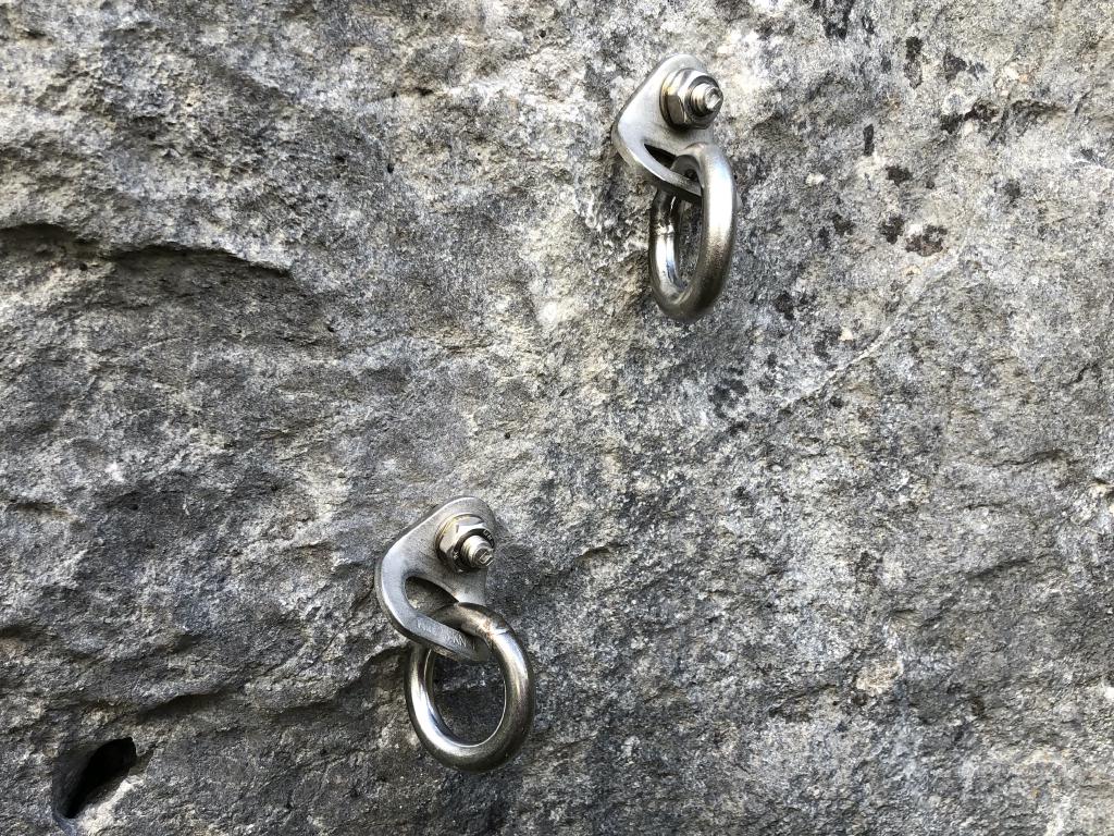 Two shiny rings, the left one is lower than the right.