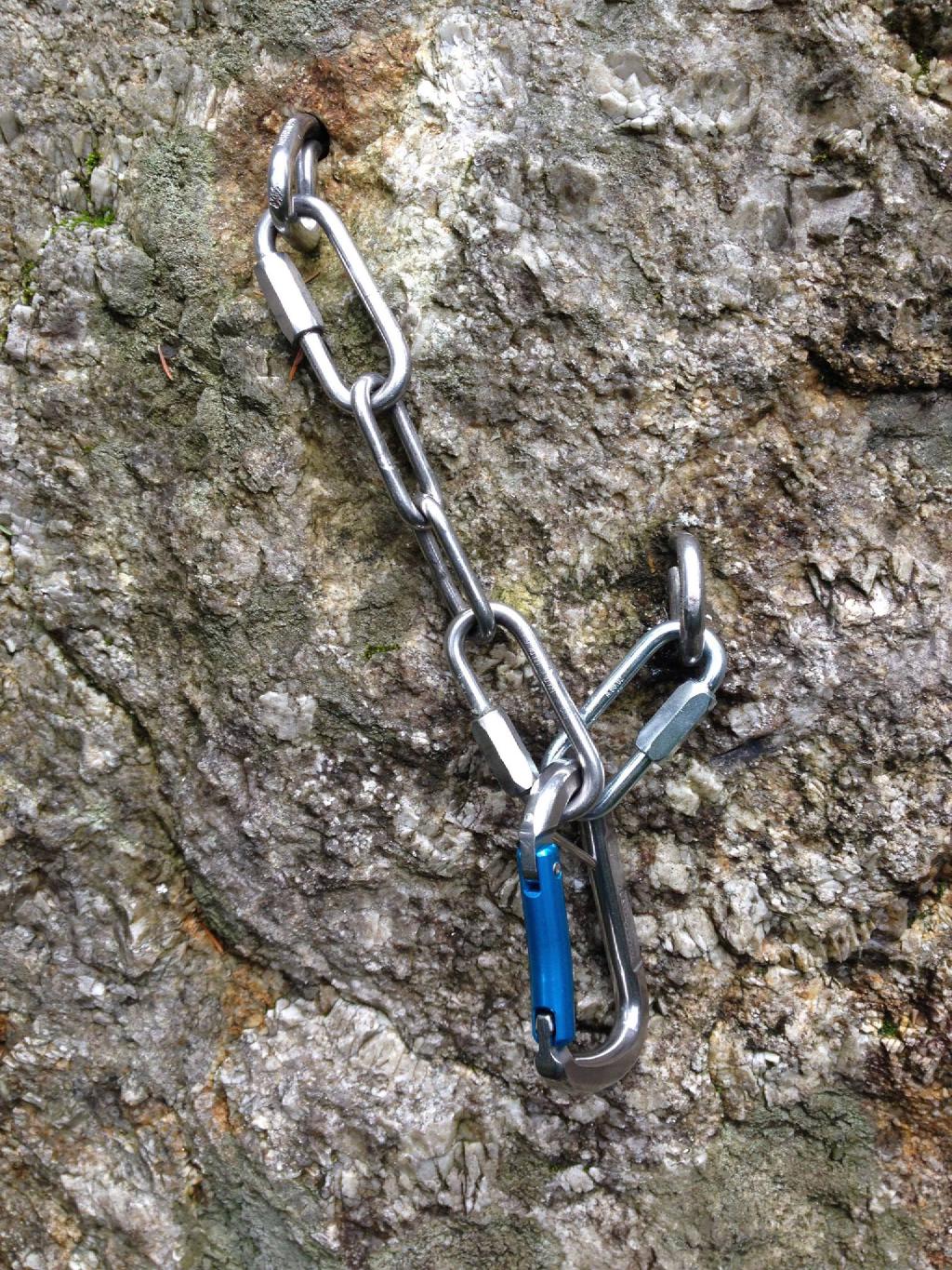 Two glue-in bolts are connected by chains to a single snapgate carabiner