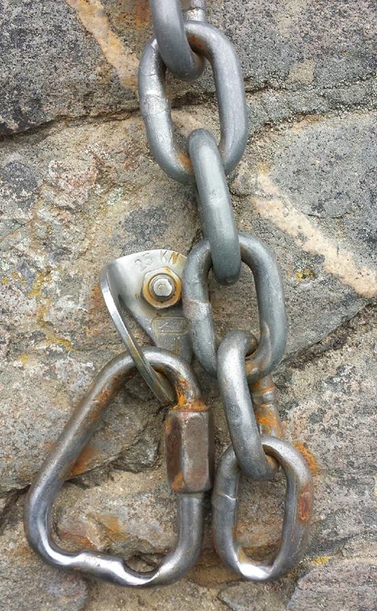 A triangle mallion with deep burrs and a worn chain